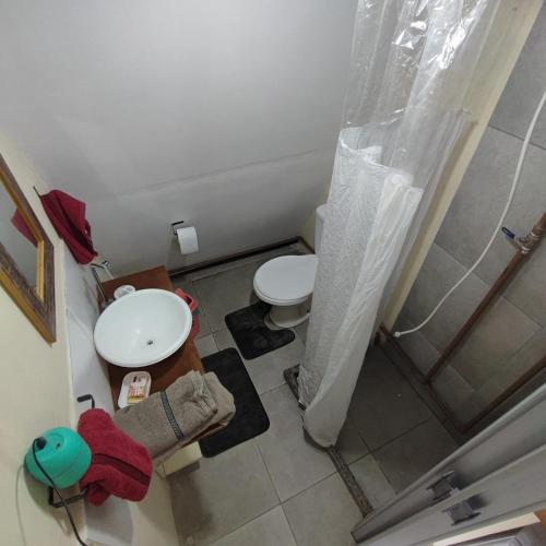 a small bathroom with a toilet and a shower at Chalés & glamping primitivo Búzios in Búzios