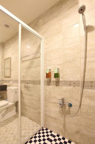 a bathroom with a shower and a toilet and a sink at My Starry Bed and Breakfast in Taitung City