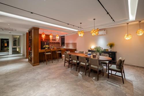 a dining room and kitchen with a table and chairs at The Ocean Suites in Danang