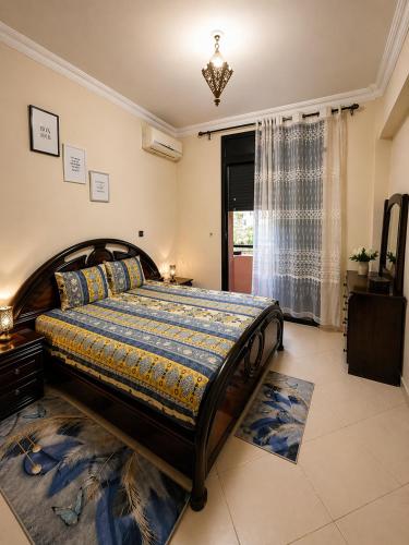 a bedroom with a large bed in a room at Résidence El Harti in Marrakesh