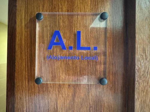 a wooden door with the al sign on it at Maria Borges Alojamento Local in Póvoa de Varzim