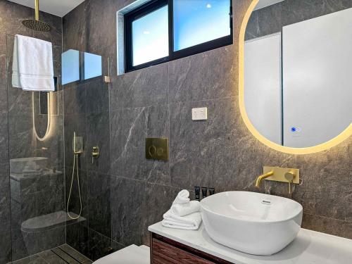 a bathroom with a sink and a mirror at Sereno in Pokolbin