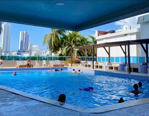 a group of people swimming in a swimming pool at Loft playa y mar in Cartagena de Indias
