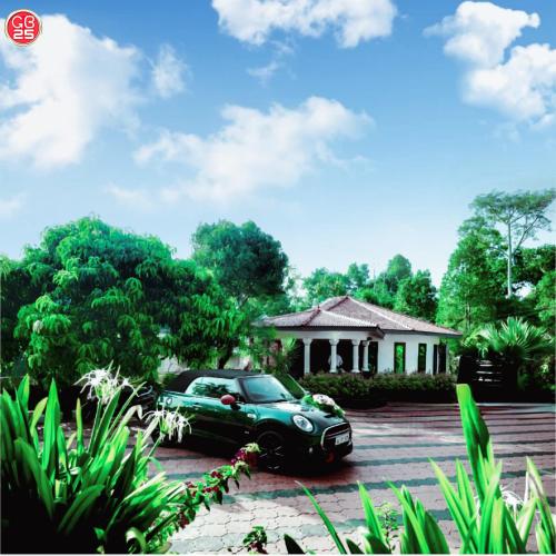 a green car parked in front of a house at GB 25 cottage's in Trivandrum