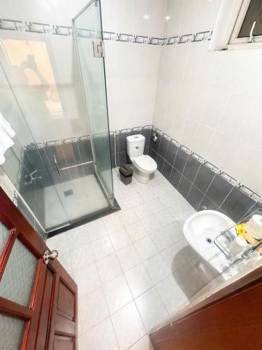 a bathroom with a shower and a toilet and a sink at Khách Sạn Á Châu Cần Thơ in Can Tho