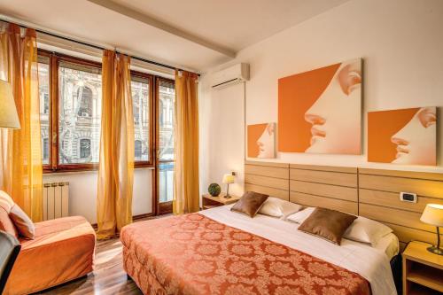 a bedroom with two beds and a large window at Trastevere Rooms in Rome