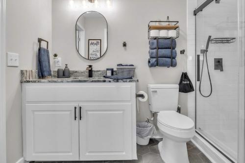 a white bathroom with a sink and a toilet at The Friendship House in Columbus