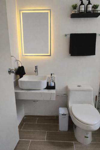a bathroom with a white sink and a toilet at Comfortable apartment with parking near AIFA in Santa Cruz Tecamac