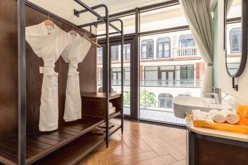 a bathroom with a sink and a bath tub with aopoulos at Lumiere Boutique Vỹ Dạ in Thôn Lại Thê