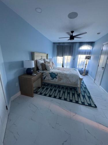 a bedroom with a bed and a ceiling fan at Buck island Breeze in Christiansted