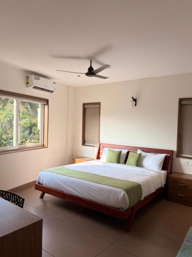 a bedroom with a large bed in a room at Cozy Nook Inn - A BB Linens Experience in Vythiri