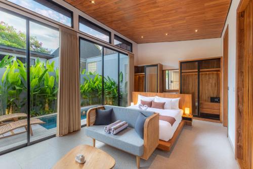 a living room with a couch and a table at Anasera Villas Echo Beach Canggu in Canggu