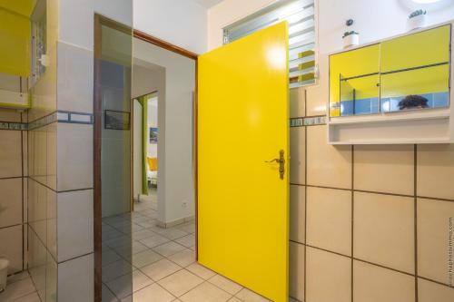 a yellow door in the middle of a kitchen at Proprizen in Rivière-Salée