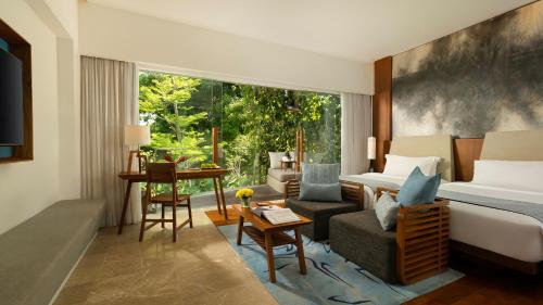 a hotel room with a bed and a desk at Maya Sanur Resort & Spa in Sanur