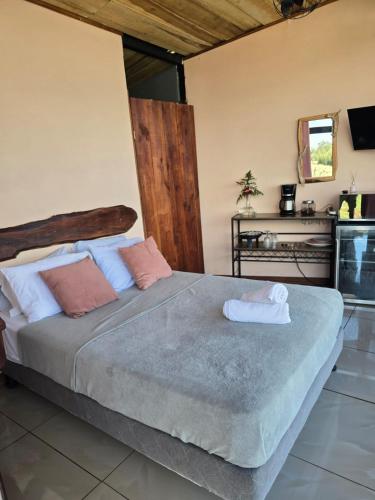 a bedroom with a large bed with towels on it at Jannah Cabaña romántica con jacuzzi in Ángeles