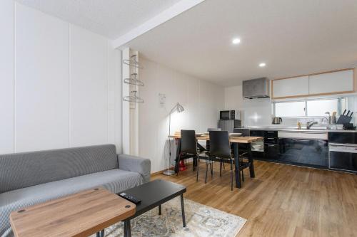a living room with a couch and a table at 金洲House 懿-下寺 in Osaka