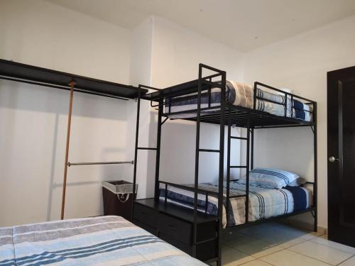 a room with two bunk beds and a bed at Casa Mojave in La Paz
