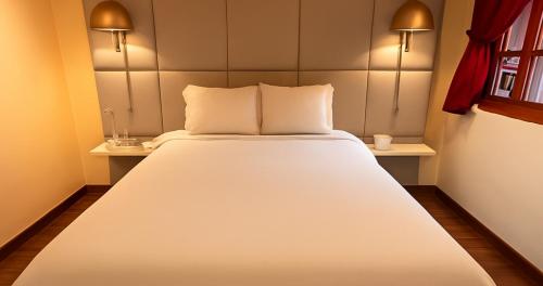 a bedroom with a large white bed in a room at Casa Dreamer Bogotá in Bogotá