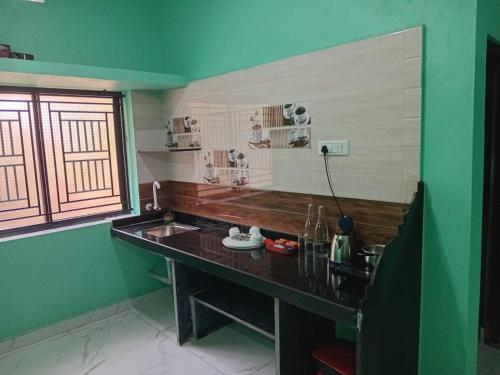 a kitchen with a sink and a counter with a window at The Triple Nest in Gokarna