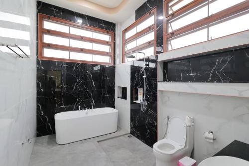 a bathroom with a white toilet and a sink at Chiang Mai Private "Davin Pool Villa" CNX 2km to Central Festival in Chiang Mai