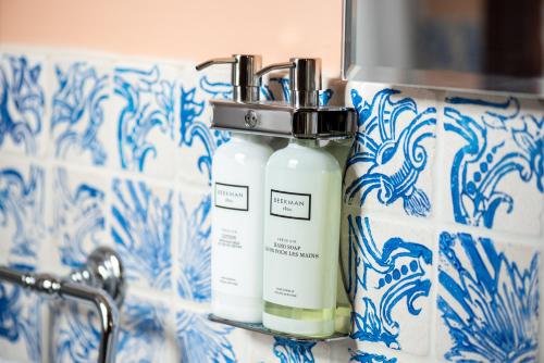 two bottles on a shelf next to a sink at Pine Brook Manor in Sparrow Bush