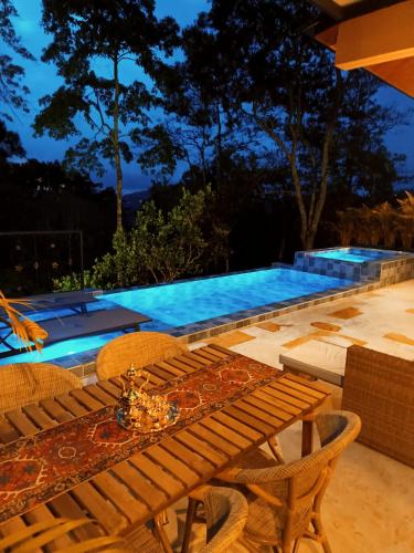 a table and chairs next to a swimming pool at Indigo House, Villa Fez in San Francisco