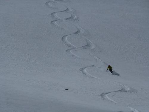 a person skiing down a snow covered slope at Tyrolean Lodge in Aspen