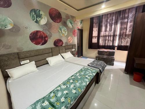 a bedroom with two beds and a wall with plates at Agam Homestay - Few Steps From golden temple in Amritsar
