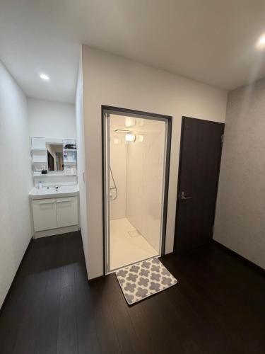 a bathroom with a shower with a glass door at waen in Karahashi Rashomon