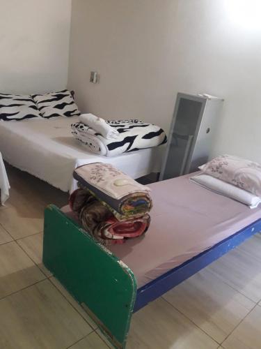 two twin beds in a room with at Posada Ña Arminda in Capitán Miranda
