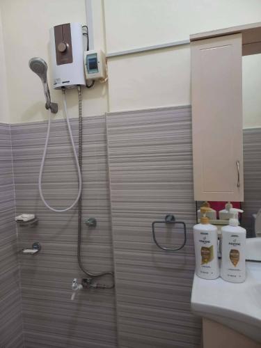 a bathroom with a shower and a toilet and a sink at Spacious Villa in Baclayon