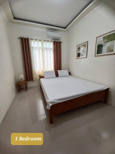 a bedroom with a large bed in a room at Spacious Villa in Baclayon
