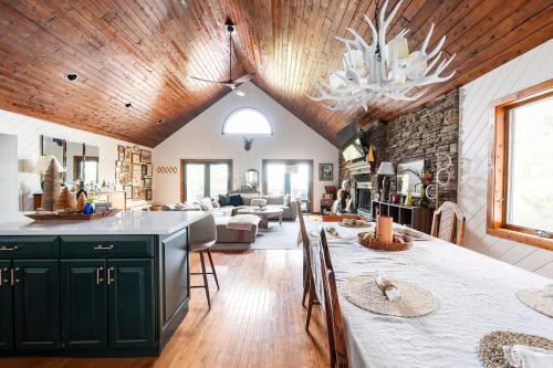 a kitchen and living room with a stone wall at Mountain View Chalet Ski, Hot Tub, Firepit, Games in Lexington