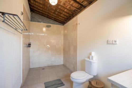 a bathroom with a toilet and a shower at Harmony Heaven Ubud by The Travel Ubud Bali in Ubud