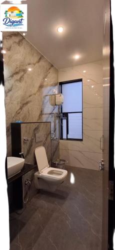 a bathroom with a toilet and a sink at Digant Home Retreat in Nevra