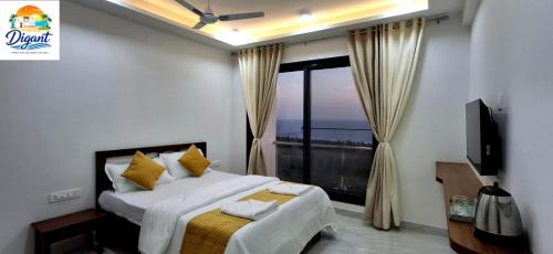 a bedroom with a bed and a large window at Digant Home Retreat in Nevra