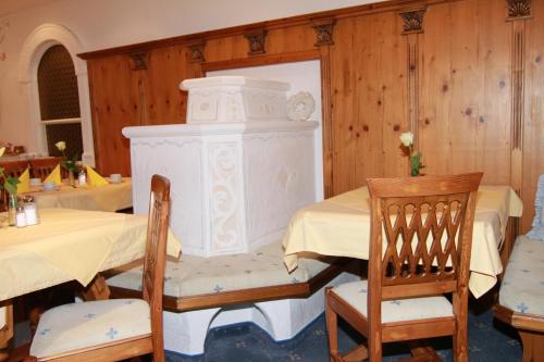 Zimmer mit einem Tisch, Stühlen und einem Kamin in der Unterkunft Mutmanör in Ischgl
