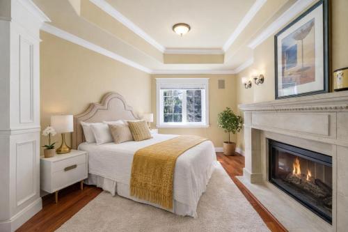 a bedroom with a bed and a fireplace at Hampton Luxe House in Coquitlam