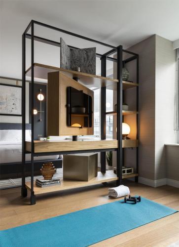 a bedroom with a black bunk bed with a blue rug at Thompson Central Park New York, by Hyatt in New York