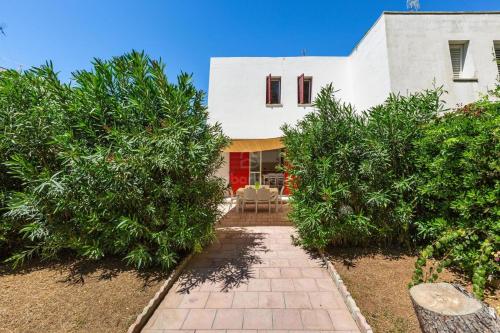 a house with trees and a walkway in front of it at 066 Le Fontanelle by SalentoInVacanzaCOM in Fontanelle