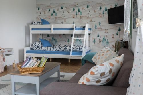 a living room with a bunk bed and a couch at Mese Szálló in Lăzarea
