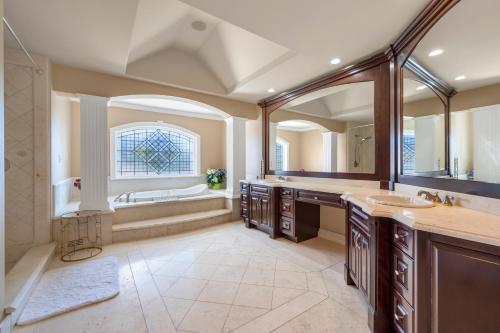 a large bathroom with two sinks and a tub at Hampton Luxe House in Coquitlam