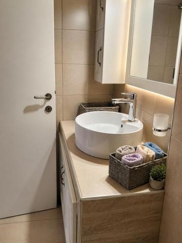 a bathroom with a sink and a mirror at Logaki house in Vlachopoulátika