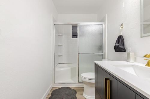a bathroom with a shower and a toilet and a sink at The Chautard Suite in Pueblo