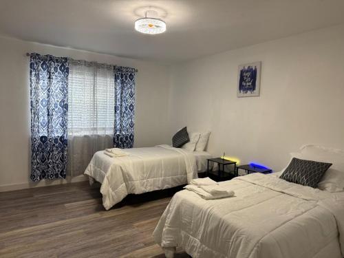a bedroom with two beds and a window at The Chautard Suite in Pueblo