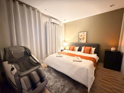 a bedroom with a bed and a chair in it at Villa Dietze in Davao City