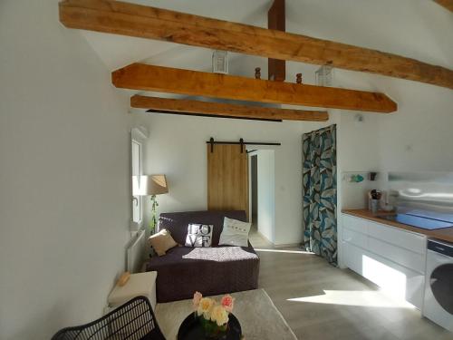 a living room with a bed and a table at Rever la Saône in Rigny