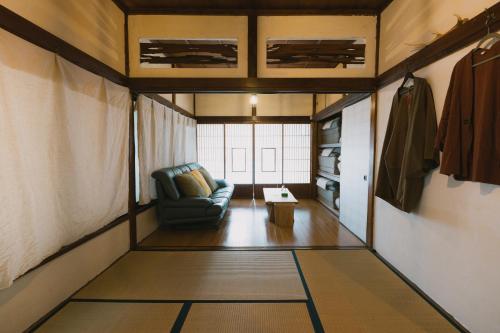 a living room with a couch and a table at Kominka Hakone Entire Traditional House in Hakone