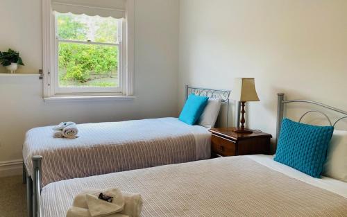 a bedroom with two beds and a window at Hidden Getaway in the City in Mount Gambier