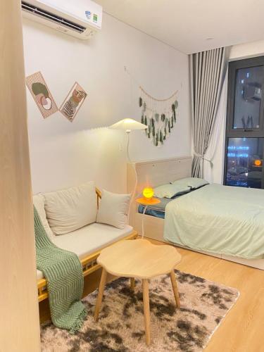 a bedroom with a bed and a couch and a table at Green Chill Studio in An Khê